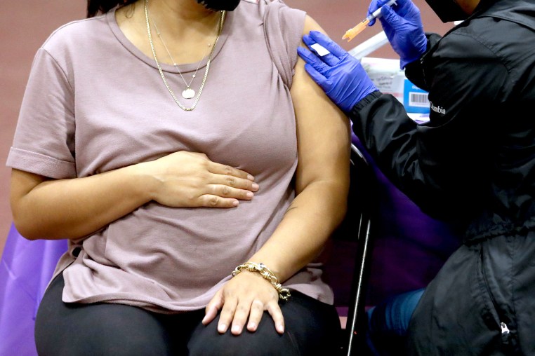 A woman receives a Pfizer vaccination booster shot in Los Angeles