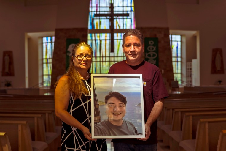 Rosa Elena Martinez and Jaime Mejia hold a photo of their son Sebastian Mejia who died of carbon monoxide poisoning in an Airbnb-rented Rio de Janeiro apartment.