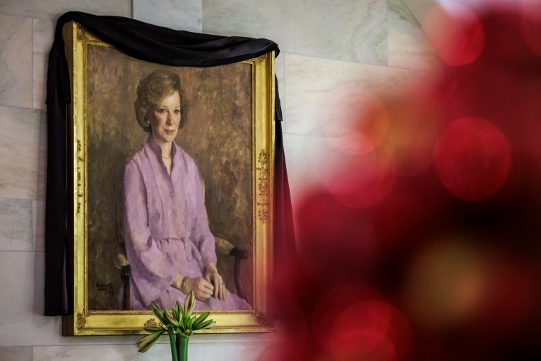 A black cloth drapes over the official portrait of former First Lady Rosalynn Carter in the ground floor corridor of the White House