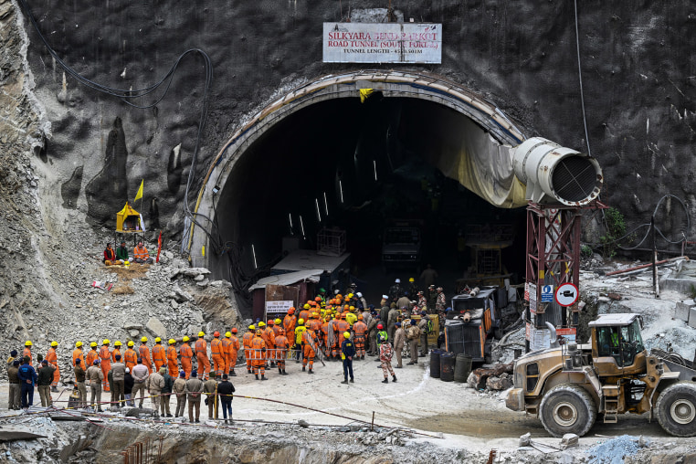 Indian rescue teams digging by hand are on the verge of breaking through to reach 41 men trapped in a collapsed road tunnel, officials said Tuesday, raising hopes the end of the marathon 17-day operation is in sight. 