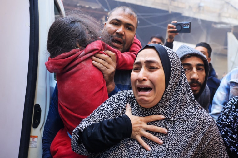 A Palestinian woman cries as injured are being transported in an ambulance following Israeli airstrikes in the refugee camp in Rafah, southern Gaza Strip, on Dec. 1, 2023, as fighting broke out shortly after the expiration of a seven-day truce between Israel and Hamas. 