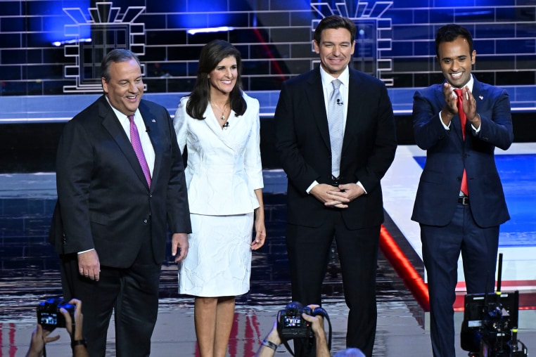 The candidates stand on stage before the start of the debate.