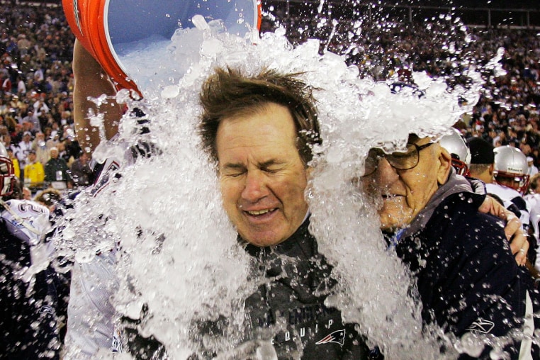 A bucket of ice is emptied on Bill Belichick.