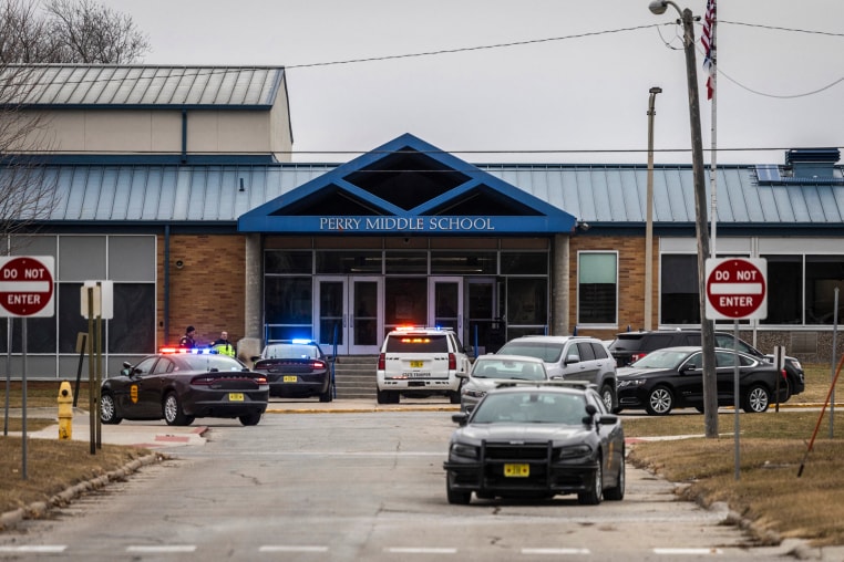 Image: Police officers secure the campus at Perry Middle and High School