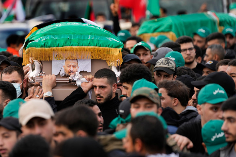 Hamas members carry the coffin of Saleh Arouri during his funeral.
