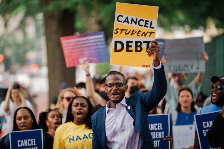 Demonstrators march from the Supreme Court to the White House after the court stuck down President Biden's student debt relief program on June 30, 2023.