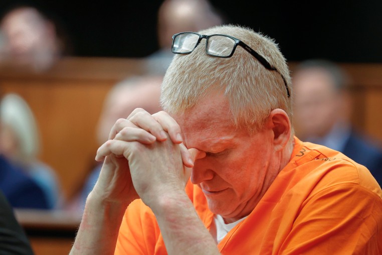 Alex Murdaugh sits with his head down during a hearing.