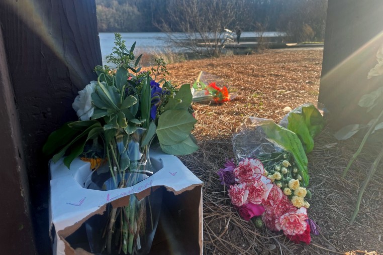 Flowers placed at a UGA campus memorial at Lake Herrick in Georgia.