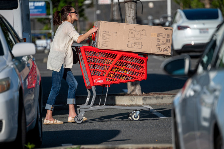 A shopper pushes a cart. 