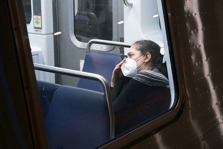 A passenger wears a mask while riding a train in Washington, D.C.