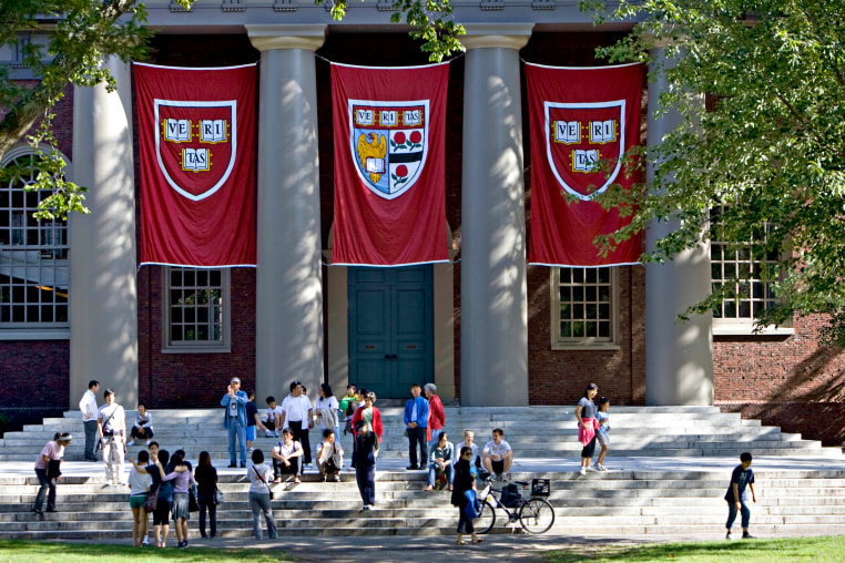 Harvard banners outside Memorial Church on the Harvard University campus in Cambridge, Mass.