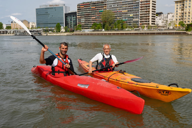 Kayakers Paul Maakad and Vincent Darnet on the Seine river in Paris.