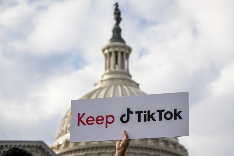 A person holds a sign supporting TikTok at the U.S. Capitol.