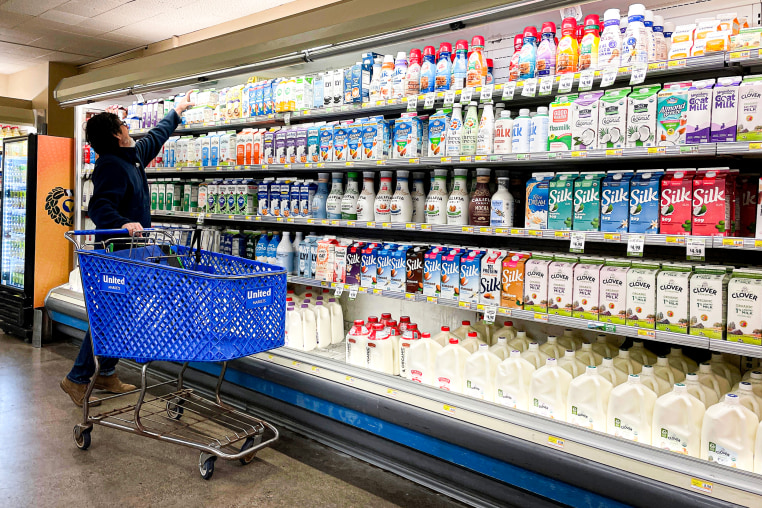 A customer shops for milk at a grocery store.