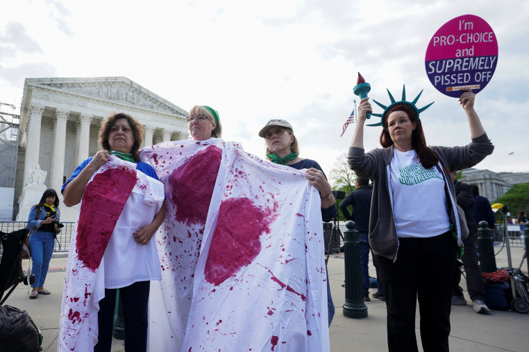 Abortion rights supporters participate in a "die-in" protest outside the Supreme Court
