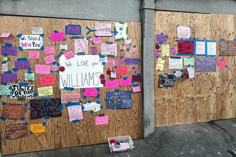 Neighbors post supportive notes on the boarded up exterior Terry Williams’ home