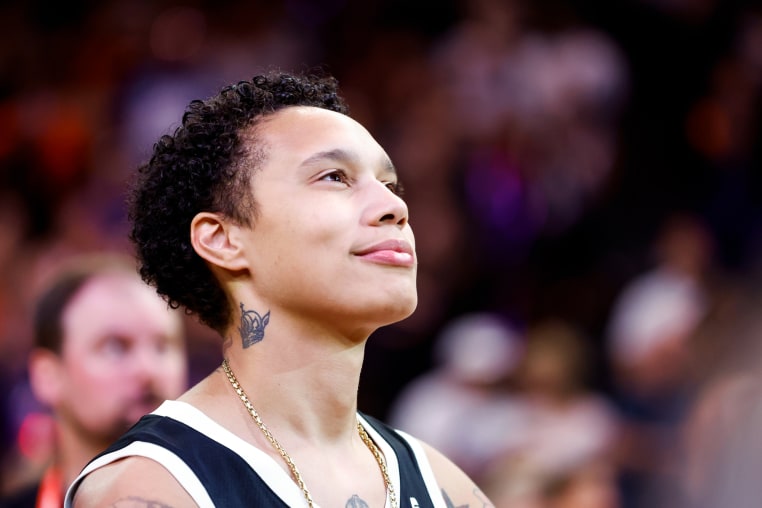 Brittney Griner smiles while looking up on the basketball court