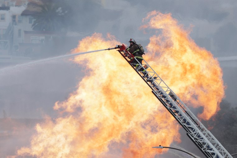 A San Francisco firefighter on a ladder 
