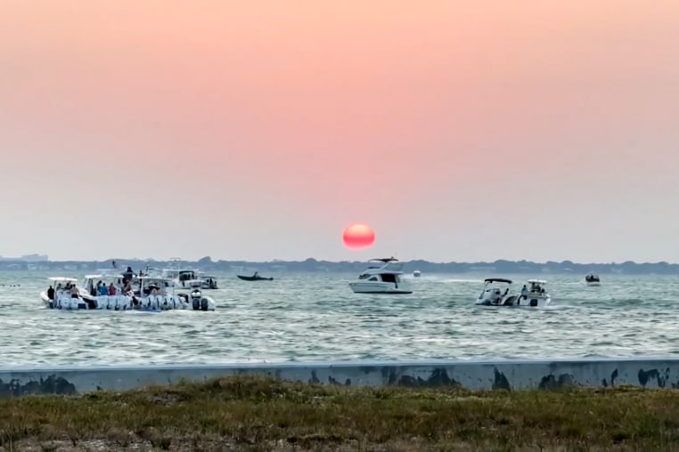 A view of Key Biscayne, Florida, at sunset with boats on the water