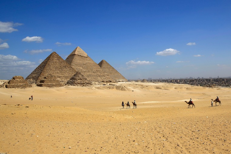 egypt giza pyramids camels tourists 