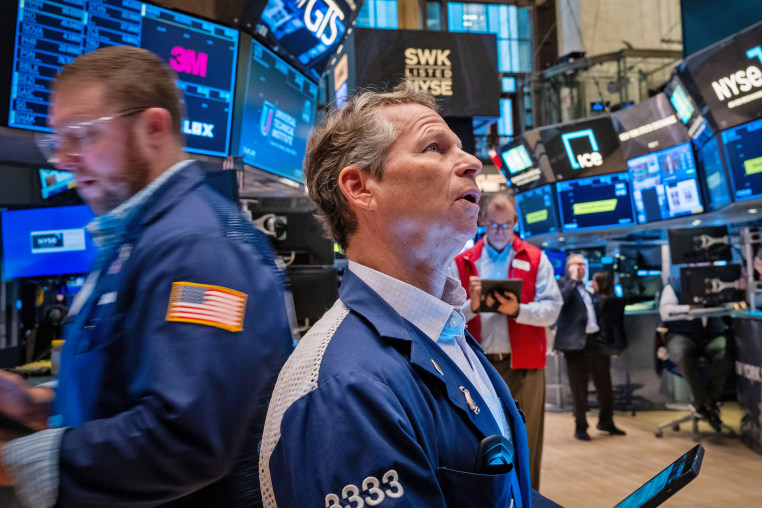 Traders walk the floor during morning trading at the New York Stock Exchange