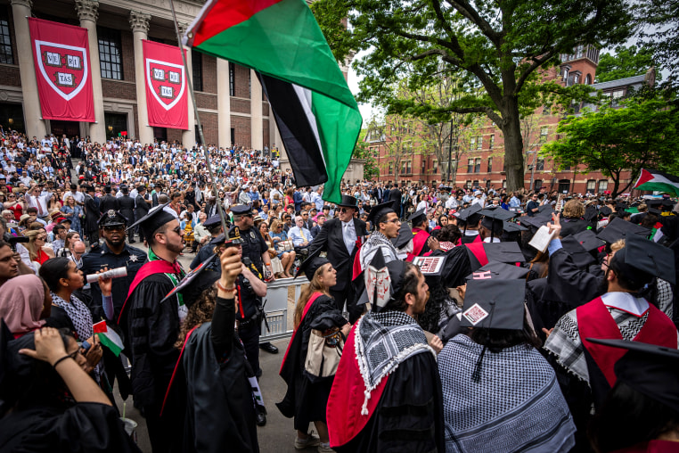 Image: Graduating Harvard students walk out in protest over the 13 students who have been barred from graduating