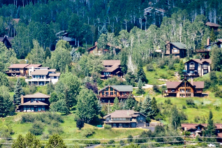 Houses dot a hillside in Steamboat Springs, Colo.