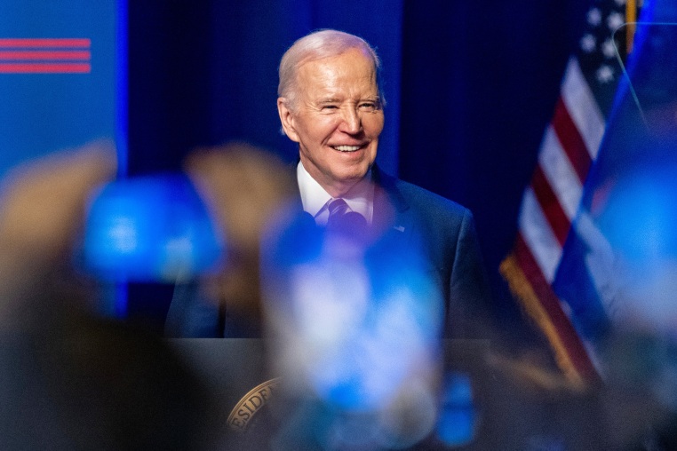 President Joe Biden smiles during an event