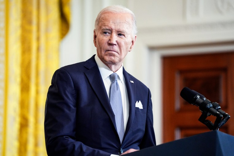 Joe Biden listens during a news conference
