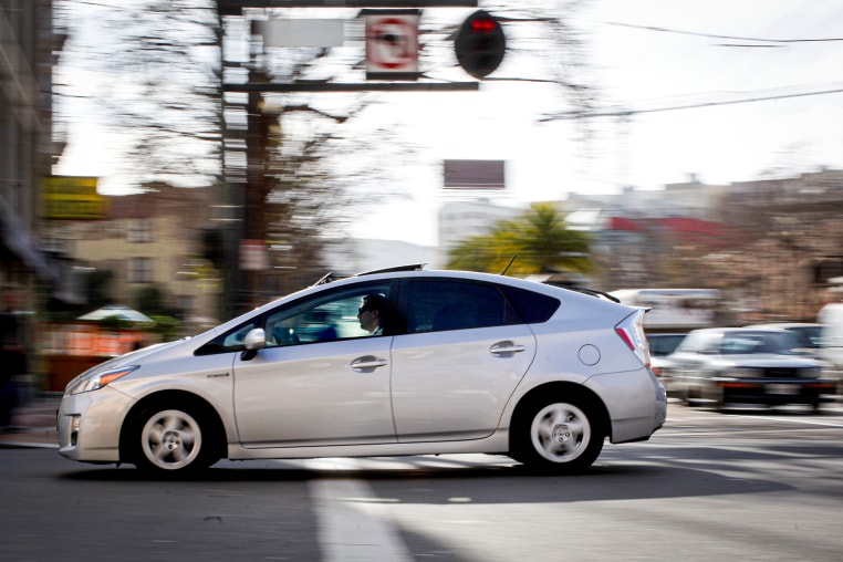 A Toyota Prius crossing a street.