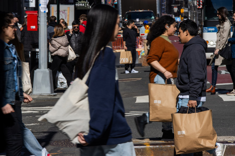 Shoppers carry bags in the SoHo neighborhood of New York City