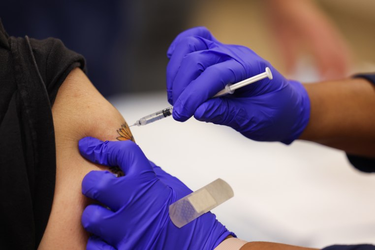 A Pfizer COVID-19 vaccine booster shot being administered in person's arm as the Mount Sinai South Nassau Vaxmobile vists Freeport High School, in Freeport, New York