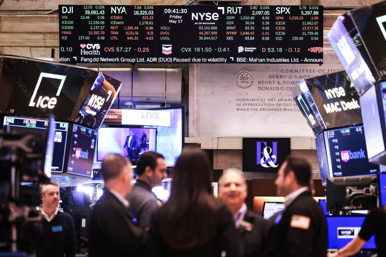 Stock market numbers are seen as traders work on the floor of the New York Stock exchange