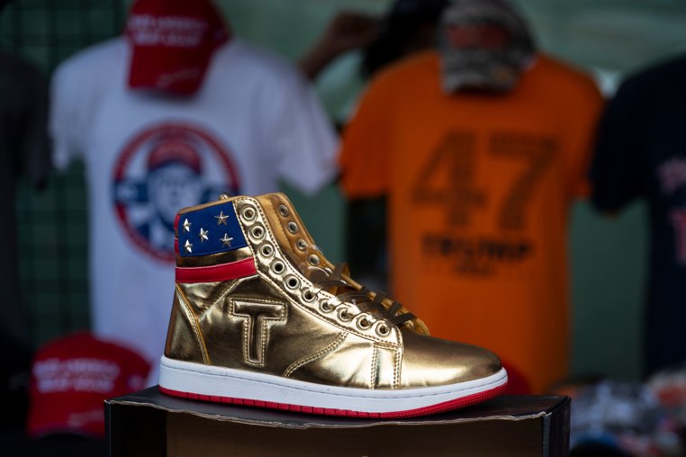 Donald Trump branded sneakers  on display in front of T-Shirts an other merchandise