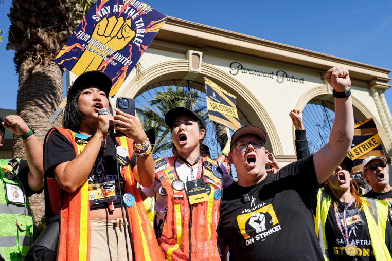 From left, Iris Liu, Miki Yamashita, and Duncan Crabtree-Ireland protest outside