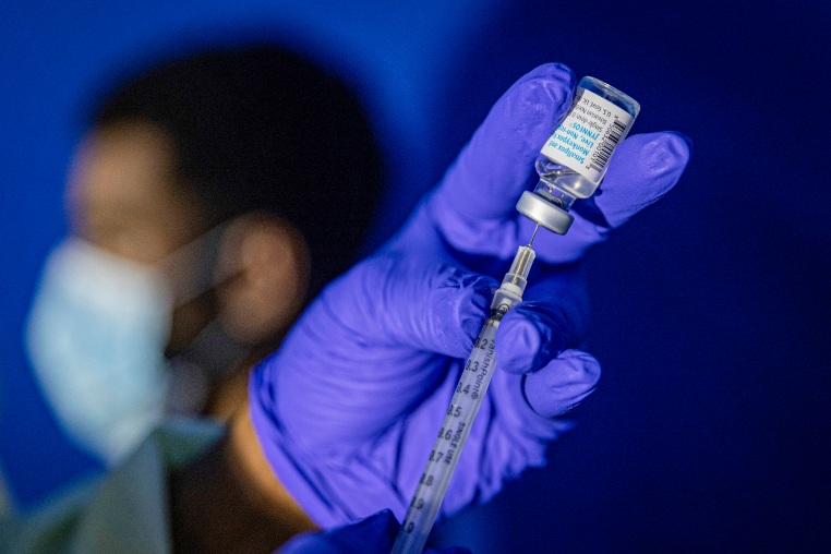 A family nurse practitioner prepares a syringe with the Mpox vaccine.