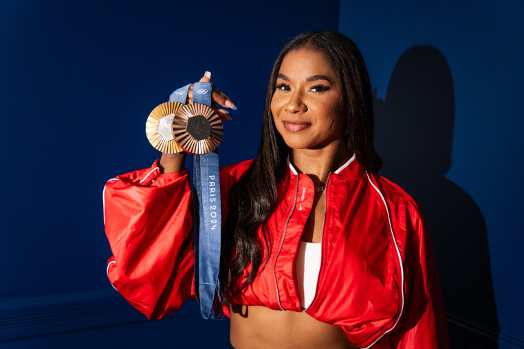 Jordan Chiles poses for a portrait holding her gold and bronze Olympic medals