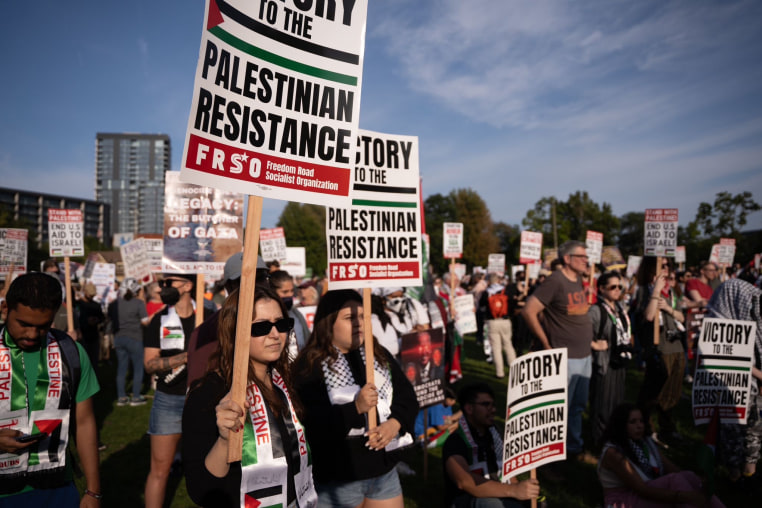 Demonstrators hold signs