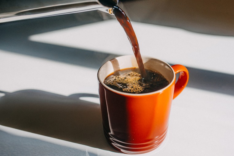 Coffee pouring in mug. 