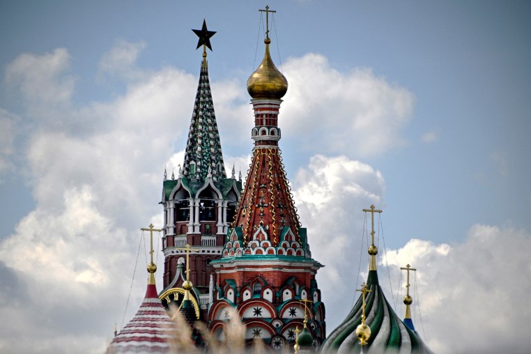 Kremlin's Spasskaya tower and St. Basil's cathedral in downtown Moscow 