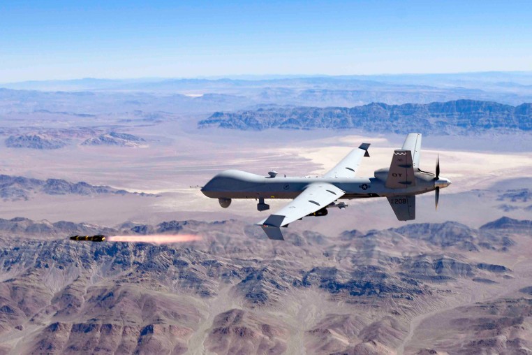 An Air Force MQ-9 Reaper fires a missile over the Nevada Test and Training Range at Nellis Air Force Base, on Aug. 30, 2023.