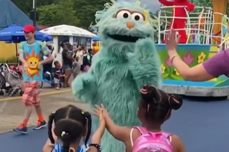 A costumed character appears to snub two Black girls at Sesame Place in Philadelphia in 2022. 