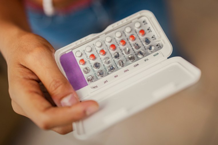 Teenage Girl Holding Birth Control Pills
