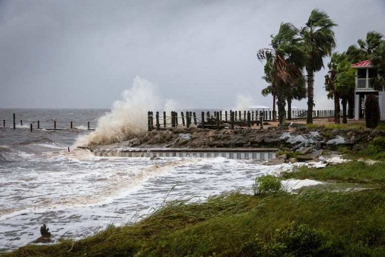 Waves impact a house seawall