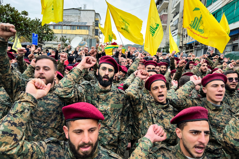 Hezbollah fighters march on the streets with flags