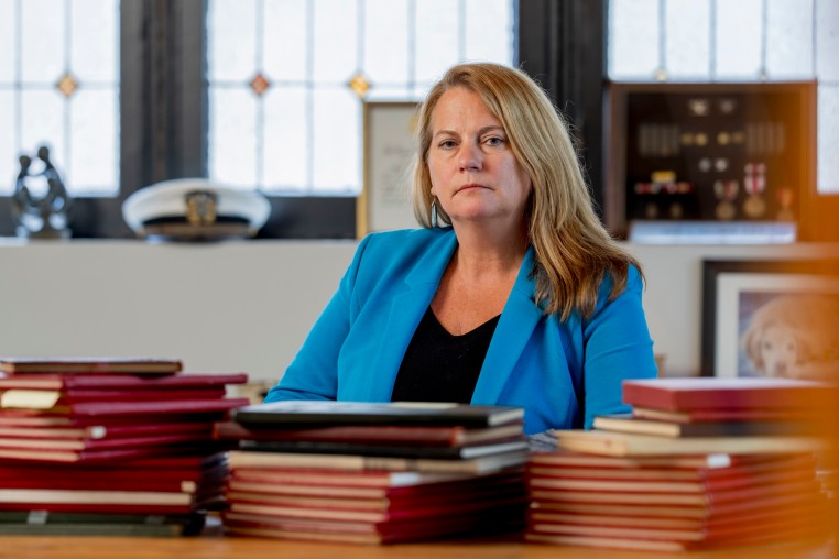 Jessie Hoerman sits with Marine Corps cruise and graduation books at her home in Clayton, Mo.