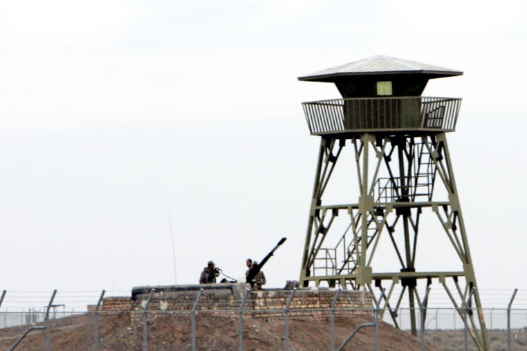 Iranian soldiers stand guard on an anti-aircraft machine gun inside Natanz uranium enrichment facility