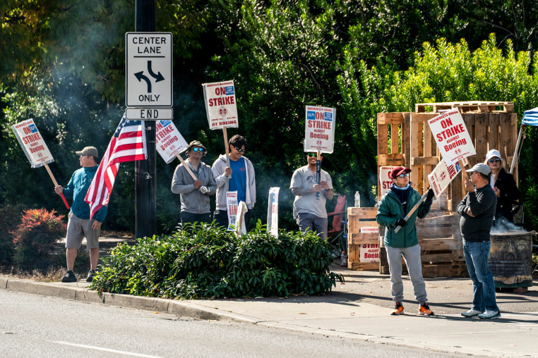 Workers picket outside the Boeing Co. manufacturing facility during a strike