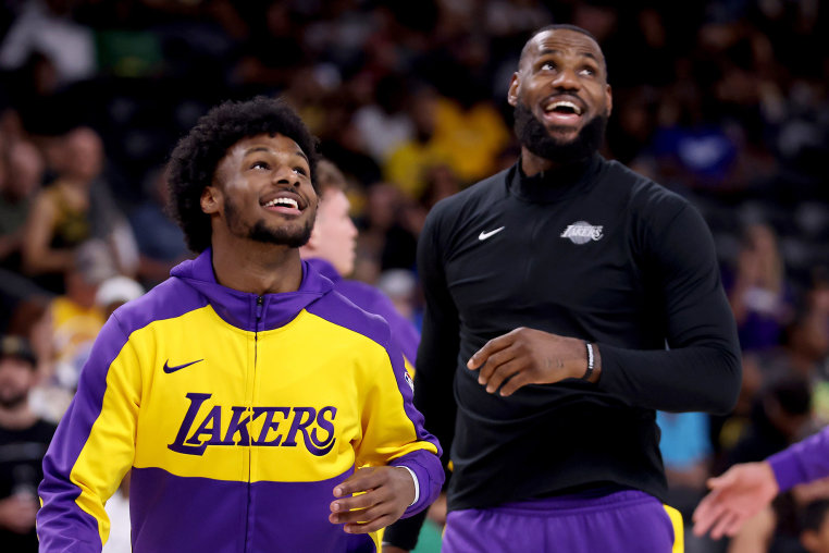 Bronny and LeBron James smile on the court