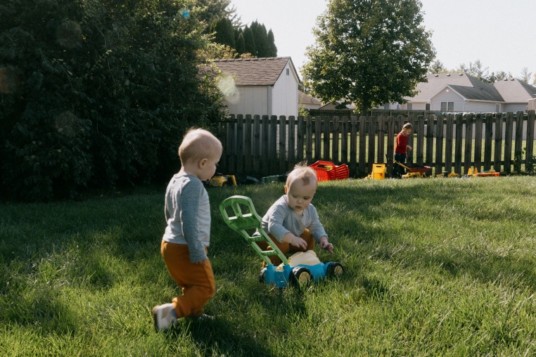 Kinser and Perry Hurley play in the backyard with their brother in Springfield, Ill., on Sept. 26, 2024.